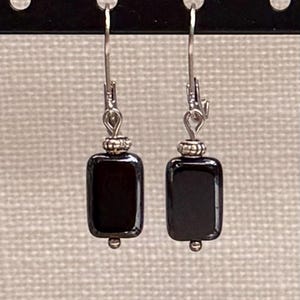 May include: A set of three ceramic mugs with a speckled, matte finish. The mugs are in shades of cream, light gray, and dark gray. Each mug has a simple, minimalist design, perfect for coffee or tea.