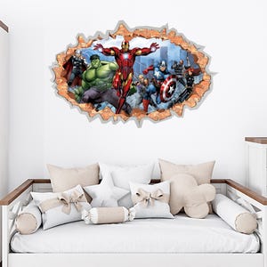 May include: A wall decal featuring a 3D effect of a brick wall with a hole revealing a cityscape and several Marvel superheroes, including Iron Man, Hulk, and Captain America. The decal is above a white bed with decorative pillows.