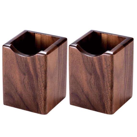 Solid walnut pen holder machined to a precise cube — the kind of quietly beautiful desk object that makes cheap plastic organizers embarrassing by comparison.