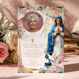 May include: A memorial card with a portrait of a woman, floral and gold embellishments. The card has Spanish text, an image of the Virgin Mary, and a dove. The background is a soft pink with floral arrangements.