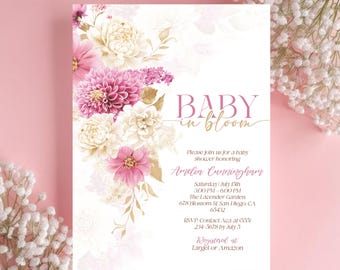 May include: A pink and white floral baby shower invitation with gold accents. The invitation reads "Baby in Bloom" and includes the name Amelia Cunningham, the date and time of the shower, the location, and RSVP information. The invitation also includes the text "Registered at Target or Amazon".