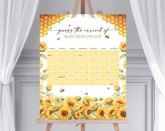 May include: A yellow and white baby shower game sign with a honeycomb pattern and sunflowers. The sign says "guess the arrival of Baby Arriana Joy" and has a calendar with the months of April, May, and June.
