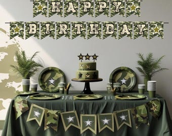 May include: A festive birthday party setup with a camouflage theme. The table is set with plates, cups, and a cake, all adorned with star accents. A banner reading "HAPPY BIRTHDAY" hangs above the table, creating a celebratory atmosphere.