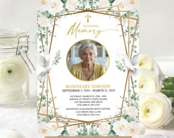 May include: A memorial sign featuring a photo of a woman, surrounded by white roses and greenery. Gold geometric shapes and the words "In Loving Memory" are at the top. The sign includes the name Rosemary Dawson and dates.