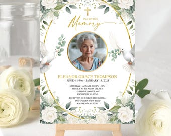 May include: A memorial card on a small wooden easel. The card features a photo of a woman within a gold frame, surrounded by white roses, greenery, and doves. The text reads "In Loving Memory" and includes the name Eleanor Grace Thompson and dates.