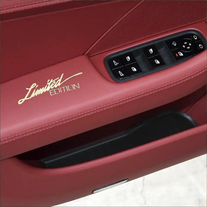 May include: A red leather car door interior with a black door panel and a gold "Limited Edition" inscription.