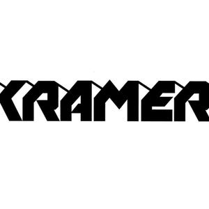 May include: Black and white logo for Kramer, a company name.