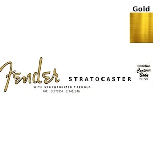 May include: A white background with the Fender logo in gold script, the word STRATOCASTER, and text indicating synchronized tremolo and patent numbers. A gold foil square is in the upper right corner. The words "Original Contour Body" are also present.