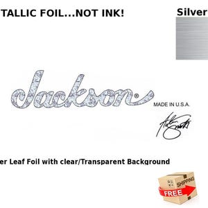 May include: Silver leaf foil decal of the Jackson logo with a clear background. The logo is in a stylized font with the word "Jackson" in all caps. The text "MADE IN U.S.A." is below the logo. A signature is below the text. The text "METALLIC FOIL... NOT INK!" is at the top of the image. The text "Silver Foil" is at the top right of the image. A sample of the silver foil is shown in the top right corner of the image.