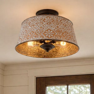 May include: A rustic ceiling light fixture with a patterned shade in shades of white and brown. The light has a dark brown base and a decorative, embossed interior. The fixture has three visible light bulbs.