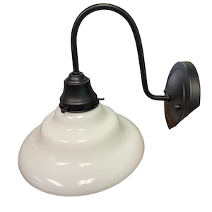 May include: A wall-mounted light fixture featuring a matte black metal arm and a circular wall plate. The fixture includes a wide, tiered, glossy white glass shade attached to the curved arm with a black metal socket and small side screws.
