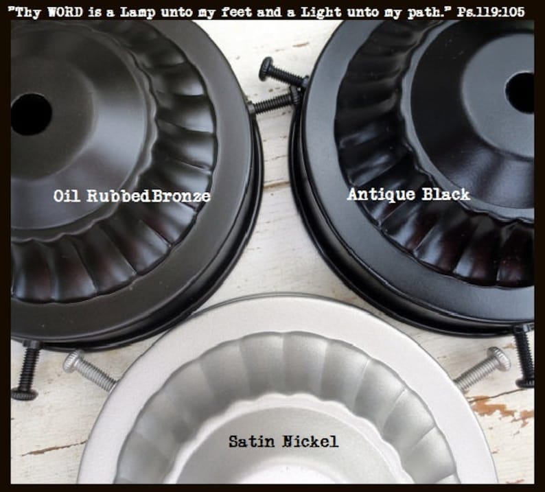 May include: Close-up of three metal ceiling fan light fixture bases in Oil Rubbed Bronze, Antique Black, and Satin Nickel finishes. The text "Thy WORD is a Lamp unto my feet and a Light unto my path." Ps.119:105 is at the top.