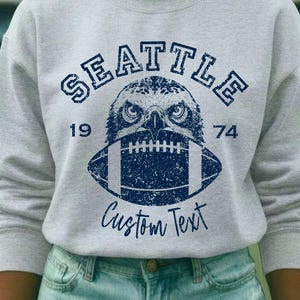 Custom Seattle Football Sweatshirt featuring Distressed Hawk Graphic Vintage 1974 Gameday Gift
