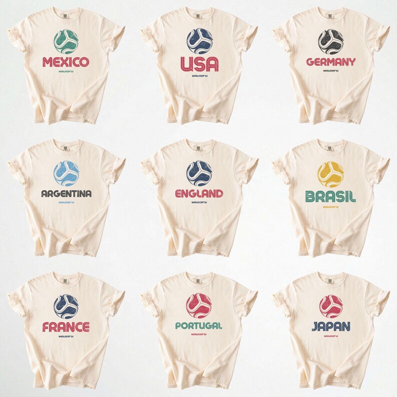 May include: Nine cream-coloured t-shirts, each displaying a country name and a soccer ball design. The shirts feature the names "Mexico", "USA", "Germany", "Argentina", "England", "Brasil", "France", "Portugal", and "Japan" in various colours.