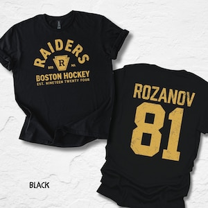 May include: Black t-shirts with gold lettering. One shirt features "RAIDERS BOSTON HOCKEY" and "EST. NINETEEN TWENTY FOUR". The other shirt displays "ROZANOV 81". The word "BLACK" is at the bottom.
