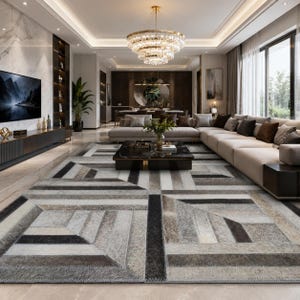 May include: A modern living room featuring a large, geometric patterned rug in shades of gray, black, and beige. The room includes a sectional sofa, a coffee table, a large television, and a crystal chandelier, creating a luxurious atmosphere.