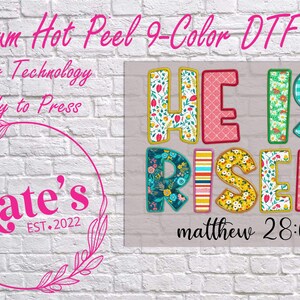 May include: A colorful DTF print with the words "HE IS RISEN" in various patterns, including floral and gingham. The text "matthew 28:6" is below. The image also includes the text "Premium Hot Peel 9-Color DTF Print".