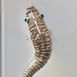 Antique articulated silver fish with green glass cabochon eyes. Spanish origin. Year 1910