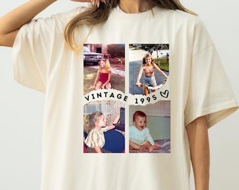 May include: A cream-coloured t-shirt with a collage of vintage photos and the text "VINTAGE 1995". The photos show different scenes, including a girl on a bicycle and a baby. The shirt has a relaxed fit and short sleeves.