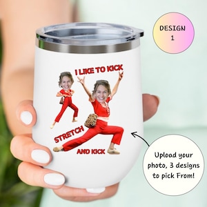 May include: White insulated tumbler with a silver rim and lid. The tumbler features a custom design with a person in a red outfit, with the text "I LIKE TO KICK, STRETCH AND KICK". A design 1 label is also visible.