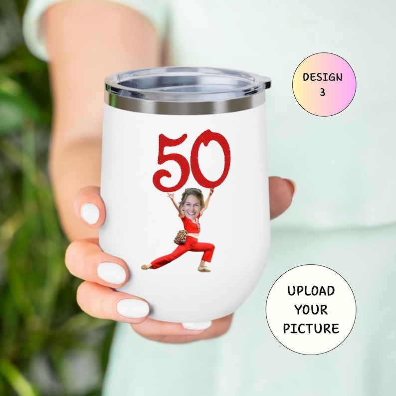 May include: White insulated wine tumbler with a silver rim and lid. The tumbler features a red "50" graphic and a cartoon image of a person holding the number. The text "UPLOAD YOUR PICTURE" is also visible.