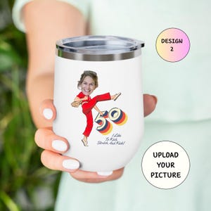 May include: White insulated tumbler with a silver lid. The tumbler features a cartoon illustration of a woman in a red jumpsuit kicking, with the number 50 and the text "I Like To Kick, Stretch, And Kick!" printed on it.