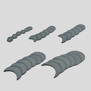 May include: Several grey, crescent-shaped craft stencils are arranged in different configurations. Each stencil features small holes and text. The stencils are displayed in rows and stacks against a light grey backdrop.