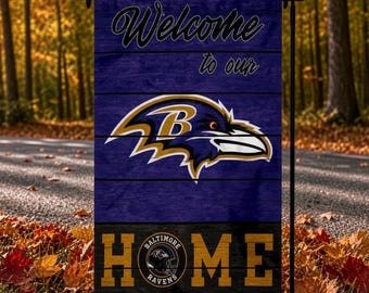 May include: A rectangular garden flag featuring a purple wood-plank background with the text Welcome to our in black script. A Baltimore Ravens bird logo is centered above the word HOME, which is printed in large yellow block letters.
