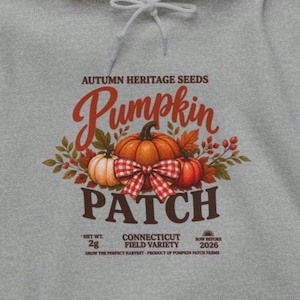 May include: A heather gray hooded sweatshirt featuring a graphic of three pumpkins with a red and white checkered bow, surrounded by autumn leaves. The text reads: AUTUMN HERITAGE SEEDS, Pumpkin PATCH, NET WT. 2g, CONNECTICUT FIELD VARIETY, SOW BEFORE 2026.