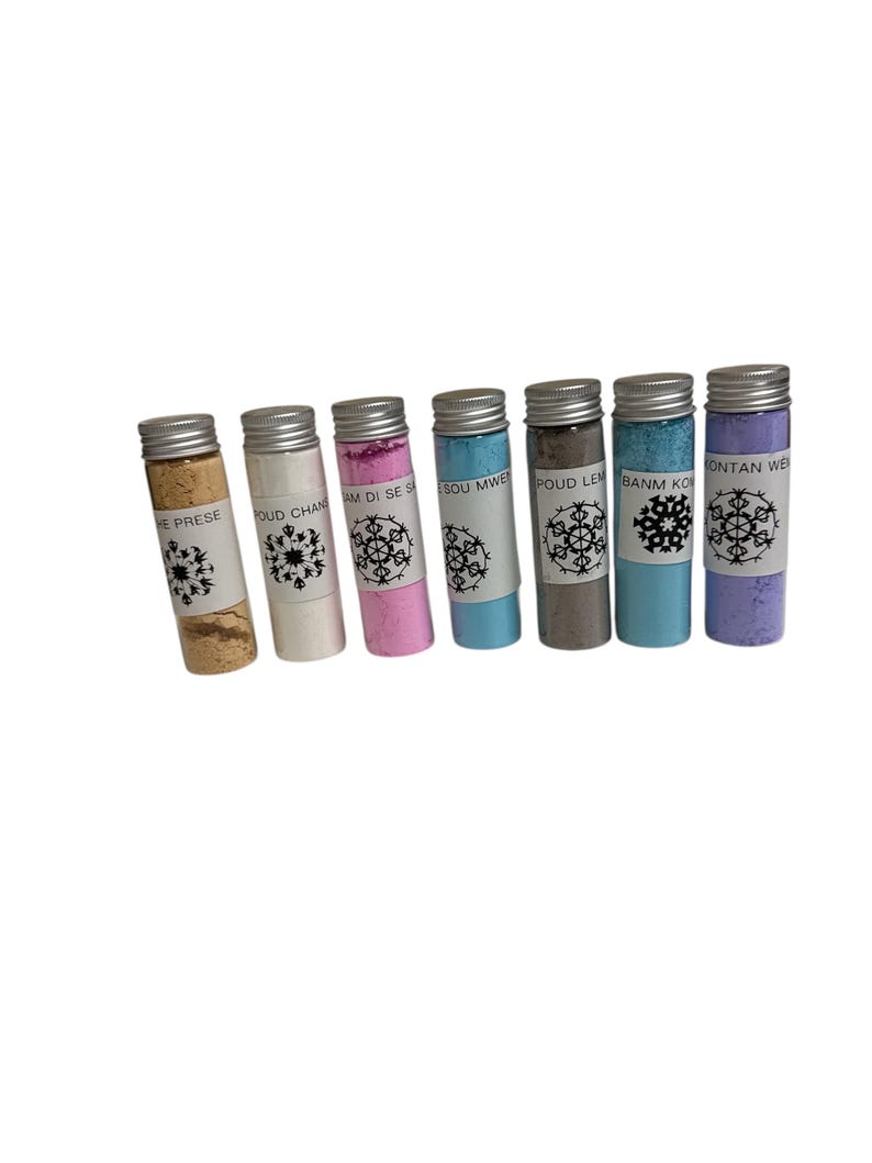 May include: Seven small glass vials with silver lids, each containing a different colored powder. The colors include beige, white, pink, blue, gray, teal, and purple. Each vial has a white label with black text and a snowflake design.