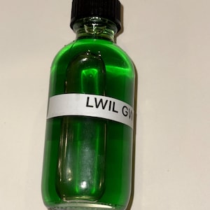 May include: A clear glass bottle filled with bright green liquid, topped with a black cap. A white label with the text "LWIL GW" is affixed to the bottle. The bottle has a rounded shape with a slightly indented area.