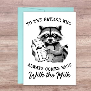 以下が含まれることがあります： 牛乳パックとグラスを持ったアライグマのイラストが描かれたグリーティングカード。「TO THE FATHER WHO ALWAYS COMES BACK With the Milk」と書かれています。カードは白で、水色の封筒が付いています。