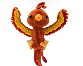 May include: A crocheted phoenix toy with orange and yellow feathers. The phoenix has a small beak and black eyes.