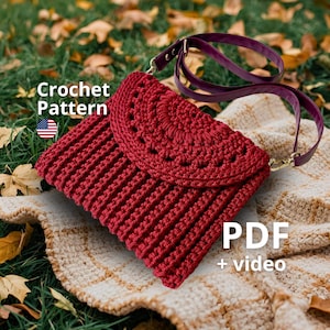 May include: A red crochet clutch with a flap closure and a detachable purple strap. The bag is made of a textured, ribbed stitch pattern. The words "Crochet Pattern" and "PDF + video" are visible in the image.