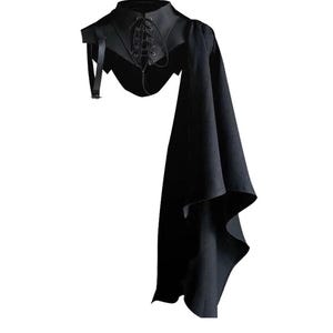 May include: Black shoulder cape with a high collar and lace-up detail. The cape features a long, flowing panel on one side and a strap with a buckle. The Shopzaan logo is in the upper left corner.