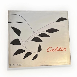 May include: A book cover with a silver background and a black and white abstract design. The word "Calder" is in red script. The publisher's name, "Phaidon," is printed in black at the bottom.