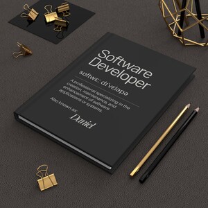 May include: A black notebook with the title "Software Developer" and the text "softwe: divelapa" written in white. The notebook also includes the text "A professional specializing in the creation, maintenance, and enhancement of software applications or systems. Also known as: Daniel".