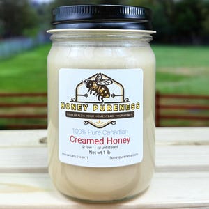 May include: A glass jar of 100% Pure Canadian Creamed Honey, labeled "Honey Pureness", with a bee logo and the text "Your health. Your homestead. Your honey."