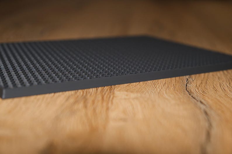 May include: A black Lego baseplate with a textured surface.