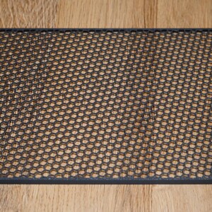 May include: A black metal mesh sheet with a hexagonal pattern.