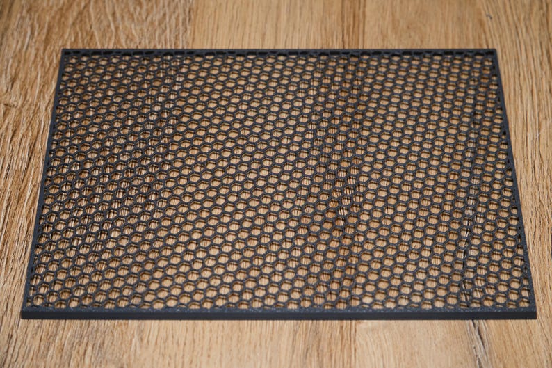 May include: A black metal mesh sheet with a hexagonal pattern.