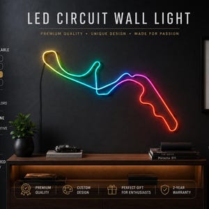 May include: An LED circuit wall light featuring a multi-coloured RGBIC neon-style track outline. The light displays a gradient of yellow, green, blue, and red. Text on the image includes LED CIRCUIT WALL LIGHT, DIFFERENT SIZES AVAILABLE, 30 CM | 11.8 IN, 55 CM | 21.7 IN, 75 CM | 29.5 IN, 100 CM | 39.4 IN, LED RGBIC VIBRANT COLOURS, SMARTPHONE CONTROL, DIMMABLE BRIGHTNESS, USB POWERED, PREMIUM QUALITY, CUSTOM DESIGN, PERFECT GIFT FOR ENTHUSIASTS, 2-YEAR WARRANTY.