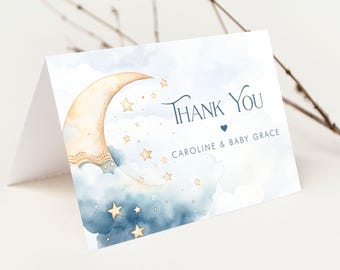 May include: A blue and gold thank you card with a crescent moon and stars. The text on the card reads "Thank You Caroline & Baby Grace".