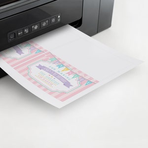May include: A printer printing out pink and white thank you cards with the text "For making Carly's 1st Birthday The Greatest On Earth!"