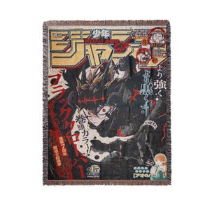 May include: A woven throw blanket featuring a manga-style illustration with Japanese text and imagery. The design includes a central figure in dark attire, set against a backdrop of bold colors and text, with fringed edges.