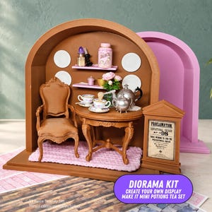 May include: A miniature brown diorama kit featuring a wooden chair, a round table with a silver teapot and teacups, two pink shelves with small accessories, a pink rug, and a sign labeled Proclamation Educational Decree No. 98.