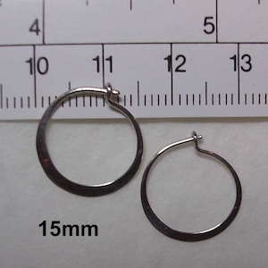 May include: Two silver hoop earrings measuring 15mm in diameter.