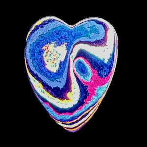 May include: A heart-shaped object with a swirling pattern of blue, white, pink, and yellow colors. The design resembles a marbled effect, with the colors blending and swirling together. The background is solid black.