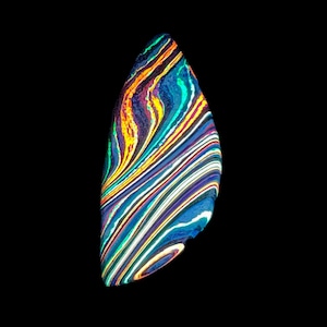 May include: A colorful, abstract, teardrop-shaped object against a black background. The object features swirling bands of color, including blue, yellow, orange, and white, creating a vibrant, textured appearance. The design resembles a gemstone or a piece of art.