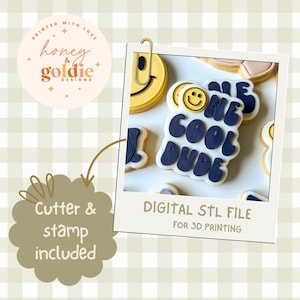 May include: A collection of decorated cookies with the words "ONE COOL DUDE" in navy blue icing. The cookies are arranged on a white surface and presented in a polaroid-style frame. The image also includes a smiley face cookie and text that reads "DIGITAL STL FILE FOR 3D PRINTING."